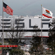 The Tesla factory outside Freemont, California with both an American and state of California flag flying outside